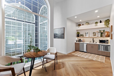 A modern kitchen with a dining table and chairs.