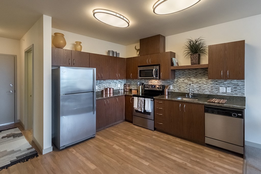 a kitchen with wooden cabinets and stainless steel appliances