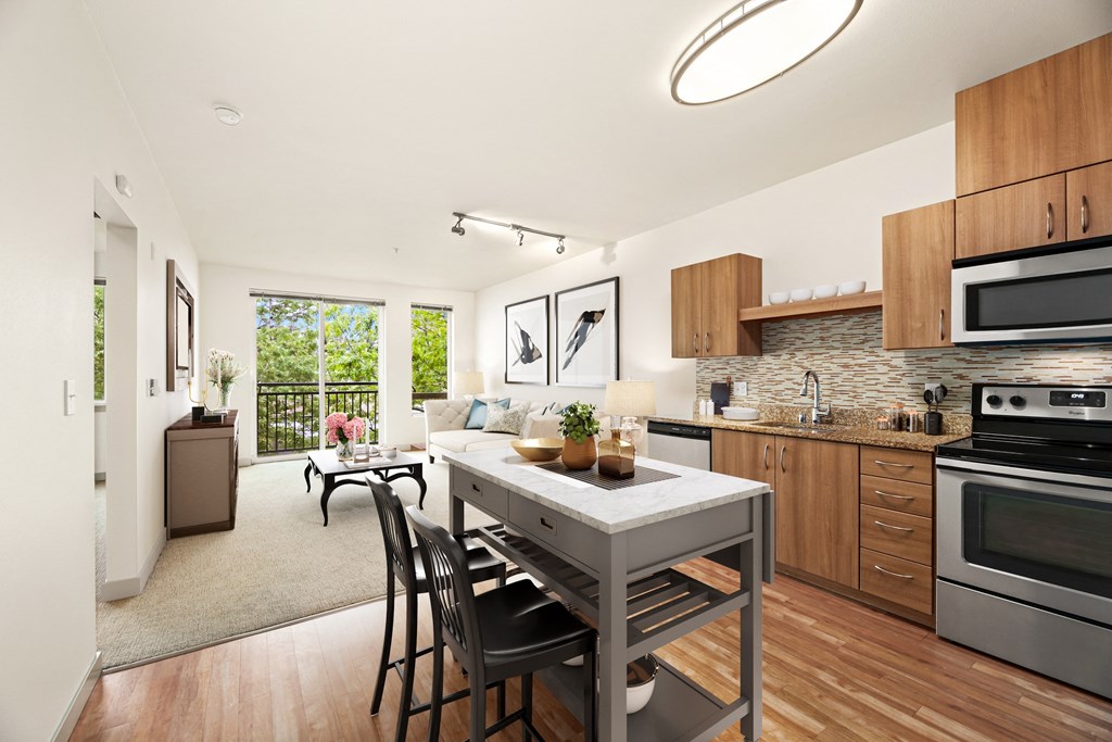 an open kitchen and living room with a table and chairs
