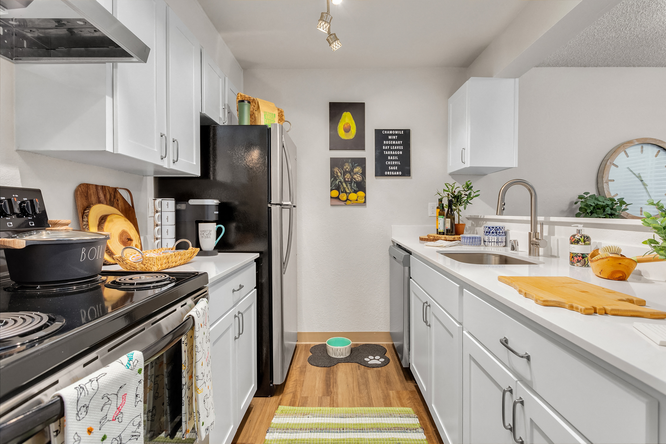 a kitchen with white cabinets and a black stove and refrigerator