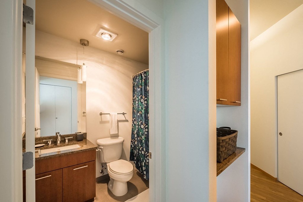 a bathroom with a toilet sink and shower