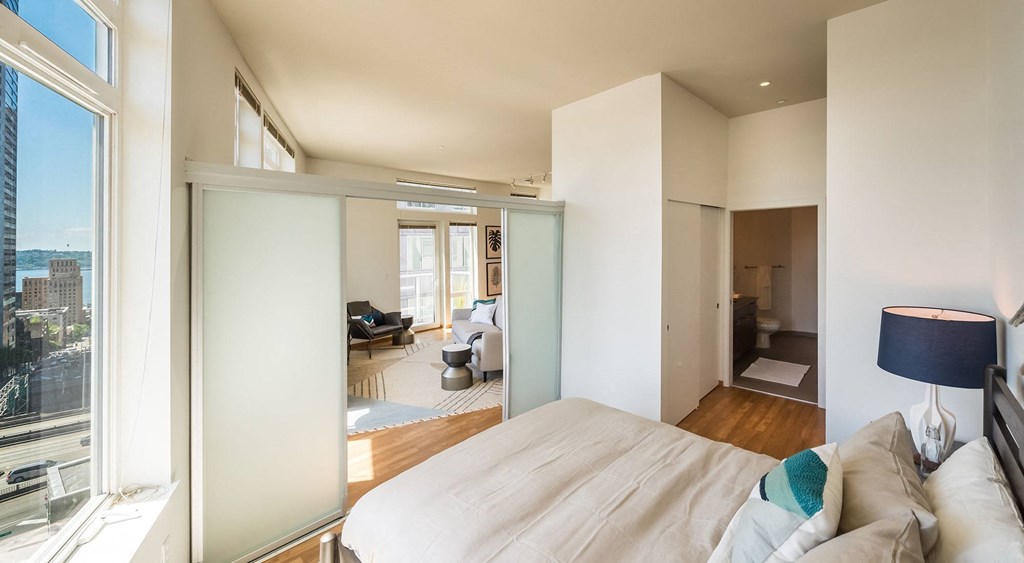 a bedroom with a large bed in front of a window