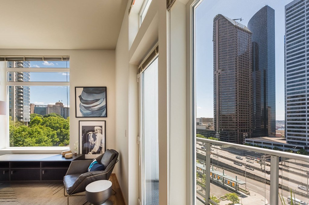 a living room with a large window and a view of a city