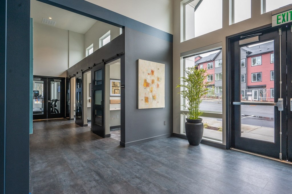 a hallway with large glass doors and a potted plant