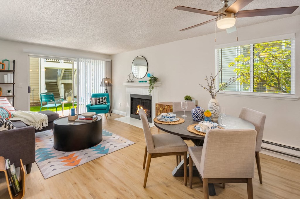 a living room with a table and chairs and a fireplace