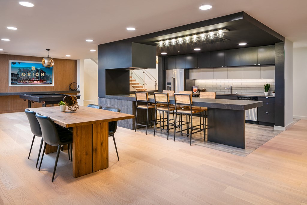 a large kitchen with a bar and a dining table