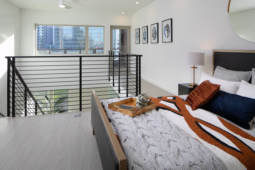 a bedroom with a bed and a balcony