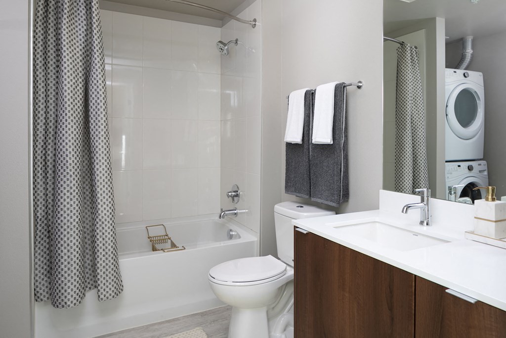 a bathroom with a toilet and a tub and a sink