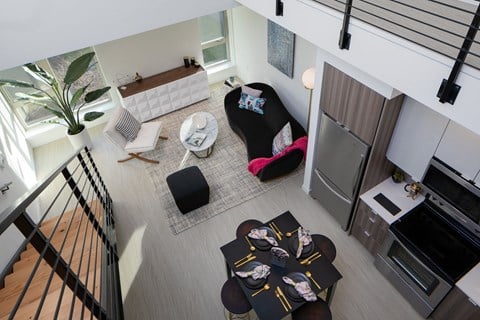 an overhead view of a living room with furniture and a staircase