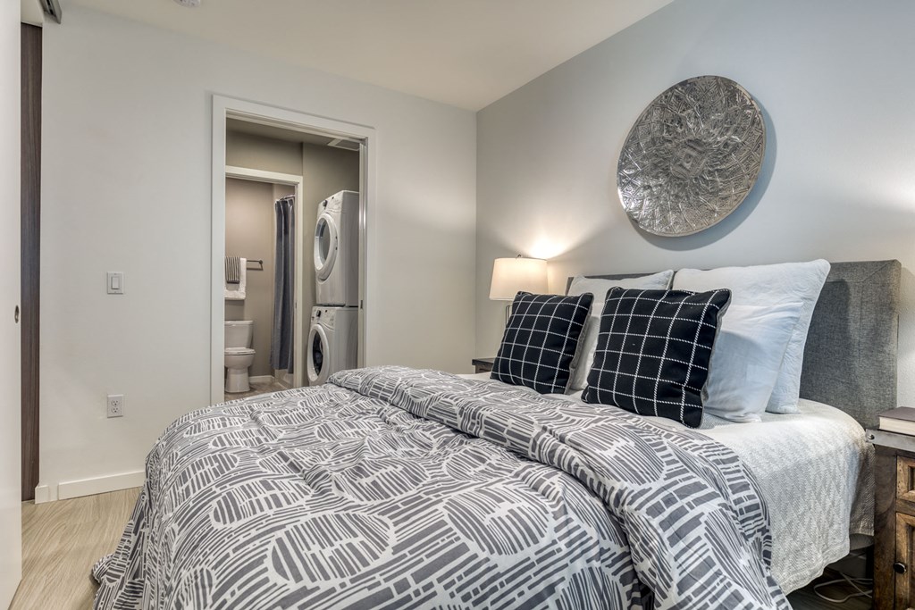 a bedroom with a bed and a bathroom with a closet