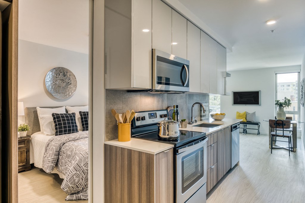 a kitchen with white cabinets and a sink and a microwave