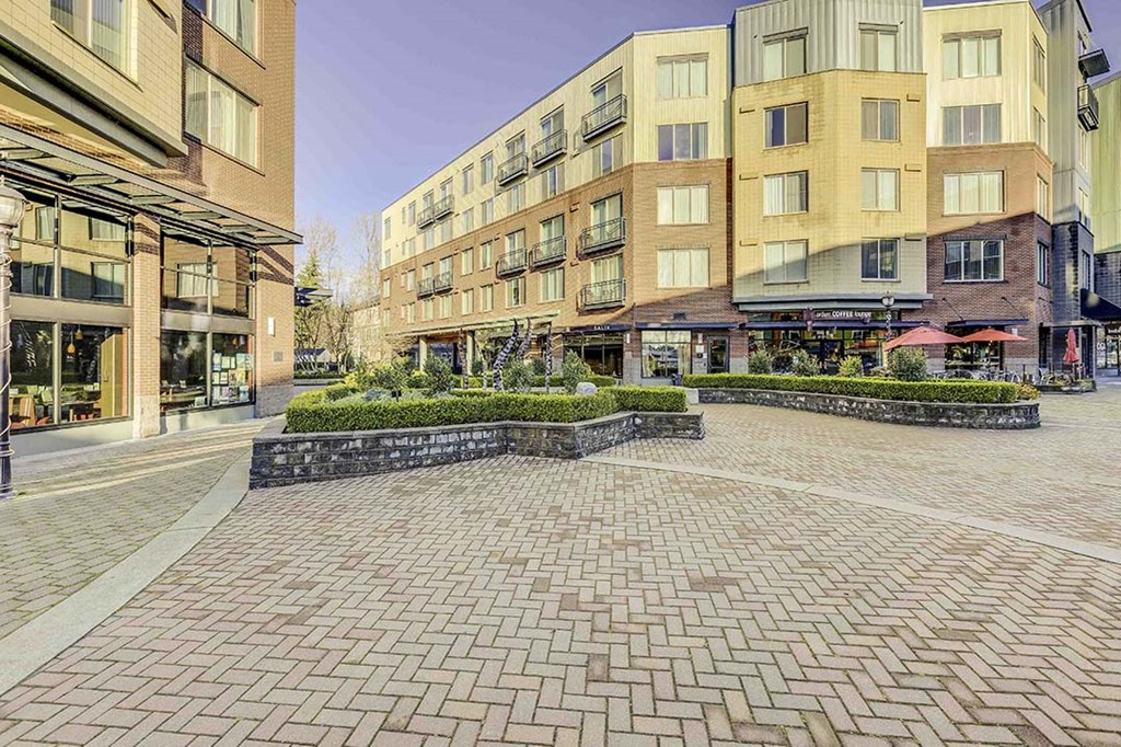 a building with a brick courtyard in front of it