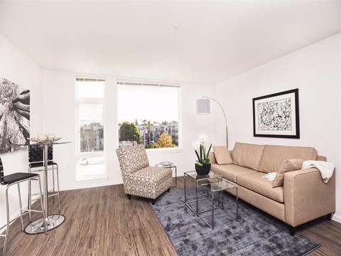 A living room with a couch, chair, and table.