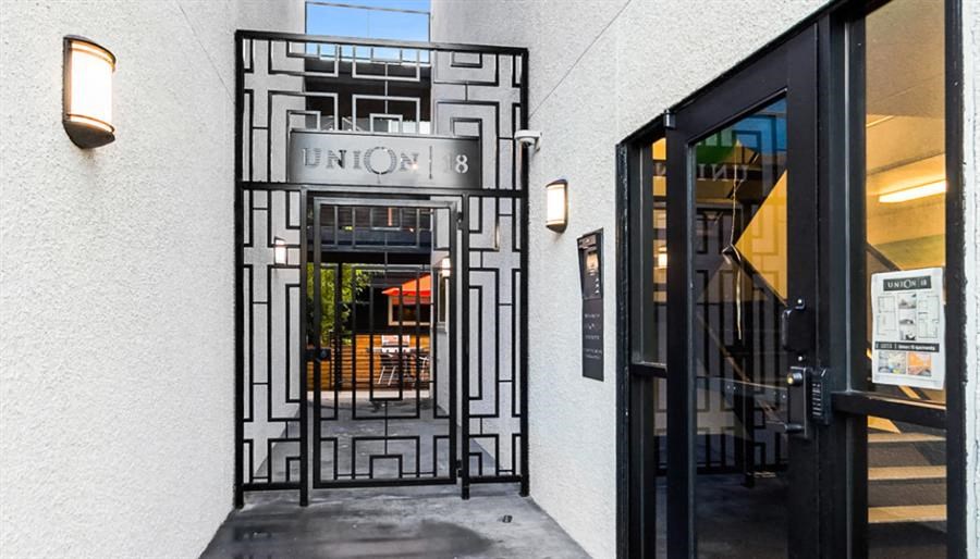 the front door of a restaurant with a wrought iron gate