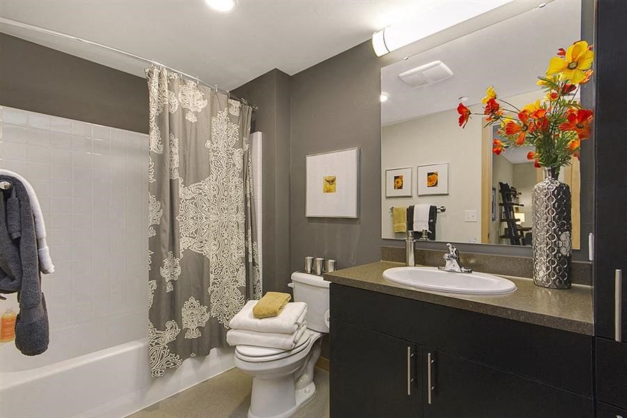 a bathroom with a toilet and a sink and a shower