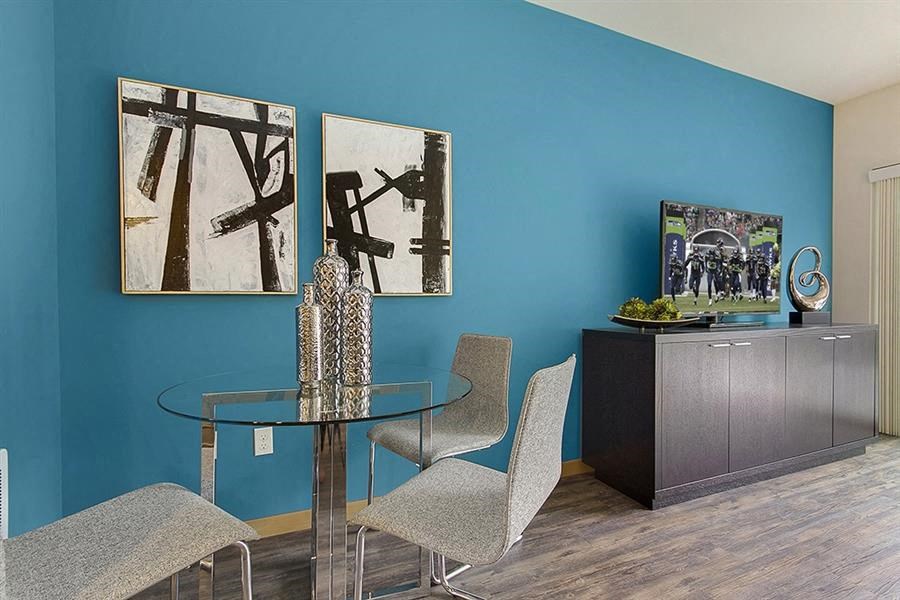 a dining room with a glass table and chairs