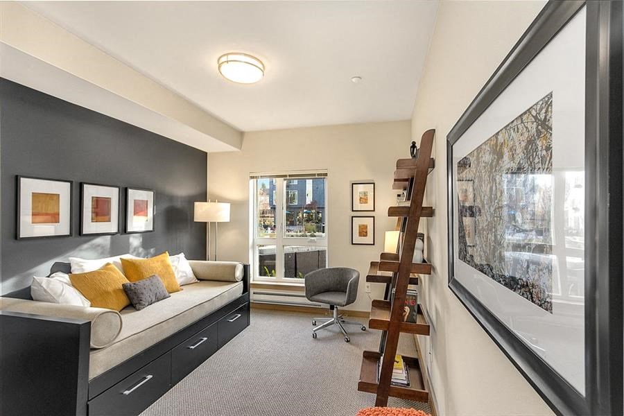 a living room with a couch and a ladder