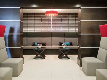 a seating area with two chairs and two tables