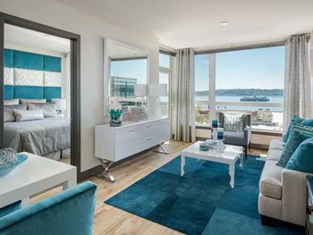 a bedroom with a bed and a desk in a room