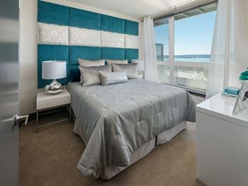 a bedroom with a large bed and a large window