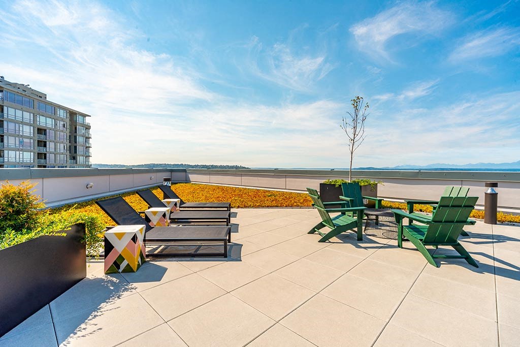 a rooftop patio with a view of the water
