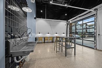 the kitchen and dining area of a brewery with a table and chairs