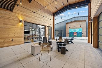 a patio with tables and chairs outside of a building
