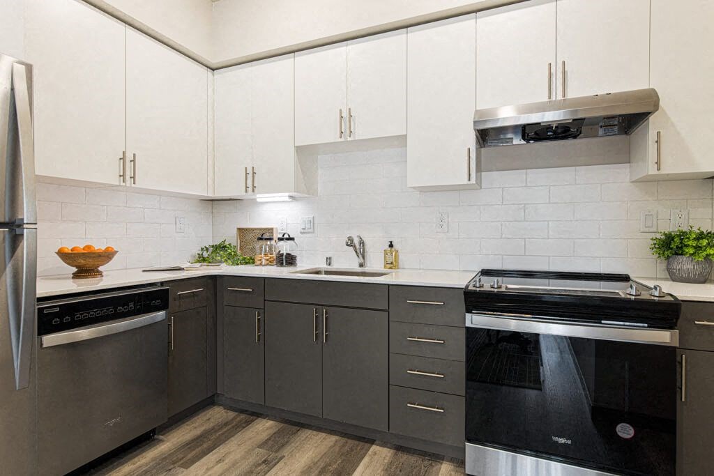 a kitchen with white cabinets and stainless steel appliances