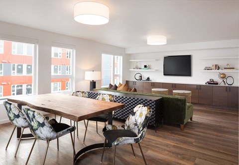 A modern dining room with a wooden table and chairs.