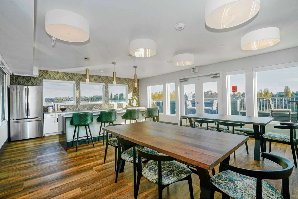 A dining room with a wooden table and chairs.