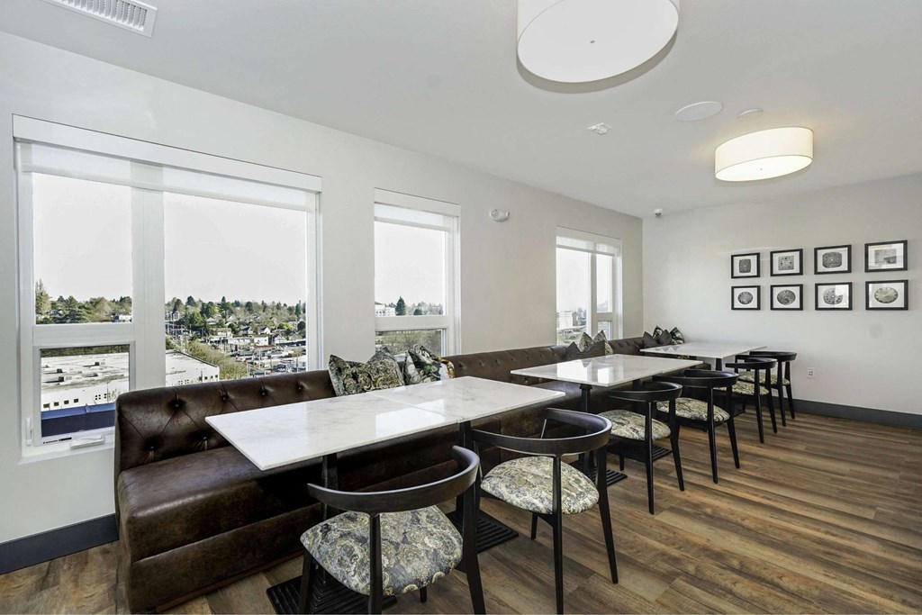 A dining room with a table and chairs.