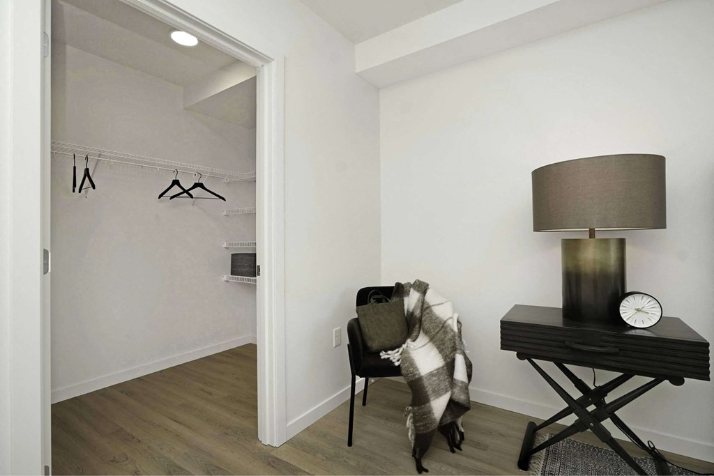 A room with a chair, a table, and a lamp.