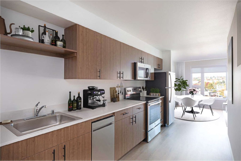 A modern kitchen with wooden cabinets and stainless steel appliances.