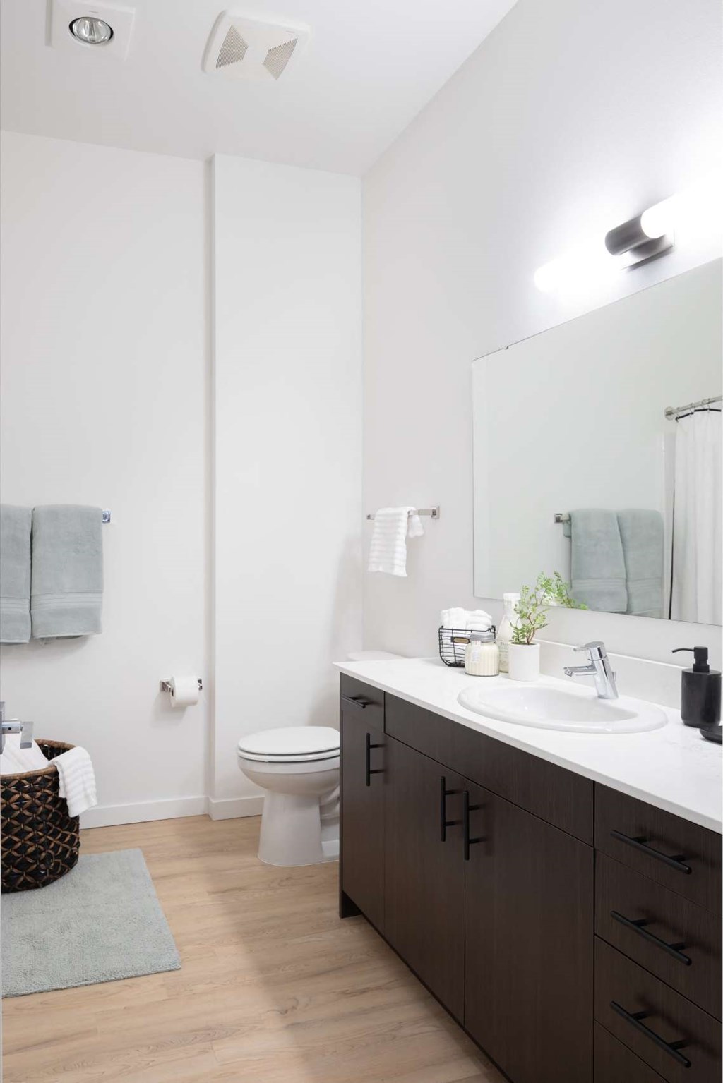 A bathroom with a white sink and a white toilet.