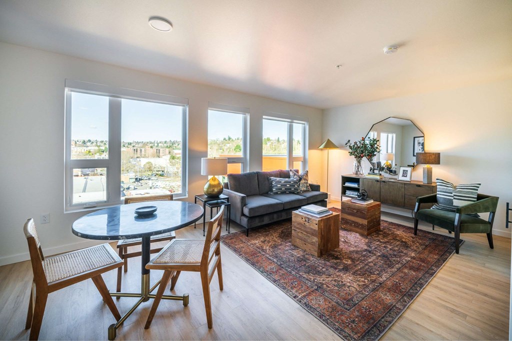 A living room with a couch, chairs, and a table.