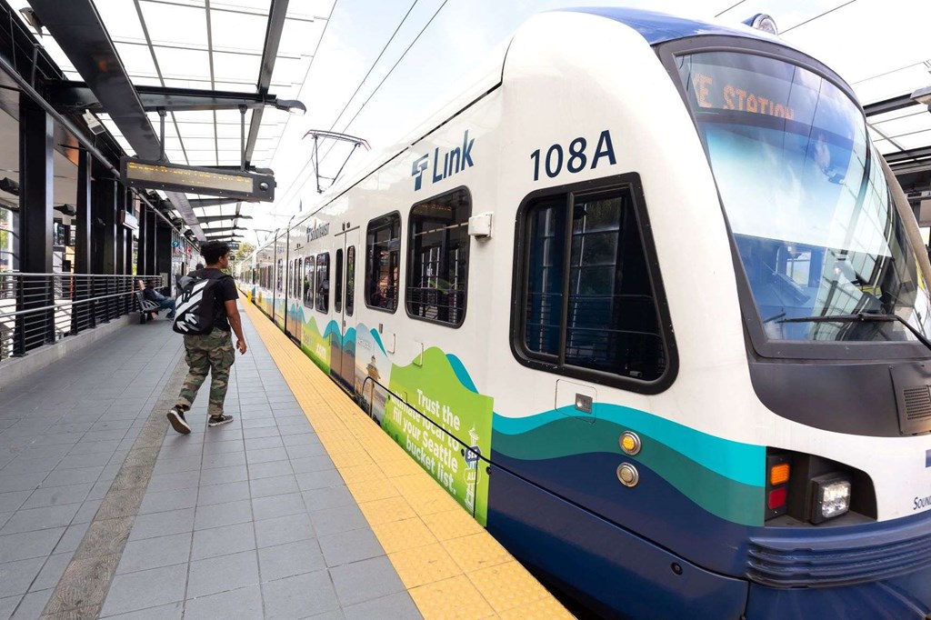 A white train with the number 108A on it is at a station.