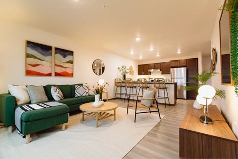 A living room with a green couch and a coffee table.
