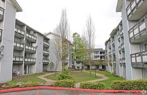 an image of an apartment building with a grassy courtyard