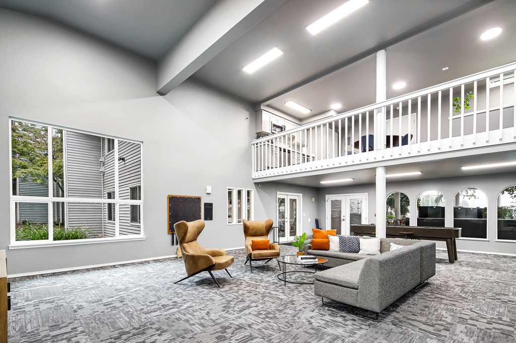 an open living room with couches and chairs