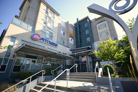 A gym named 24 Hour Fitness is located in a modern building.