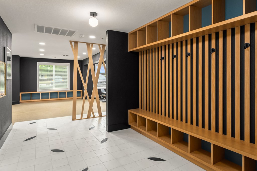 a lobby with wooden shelves and a white tiled floor