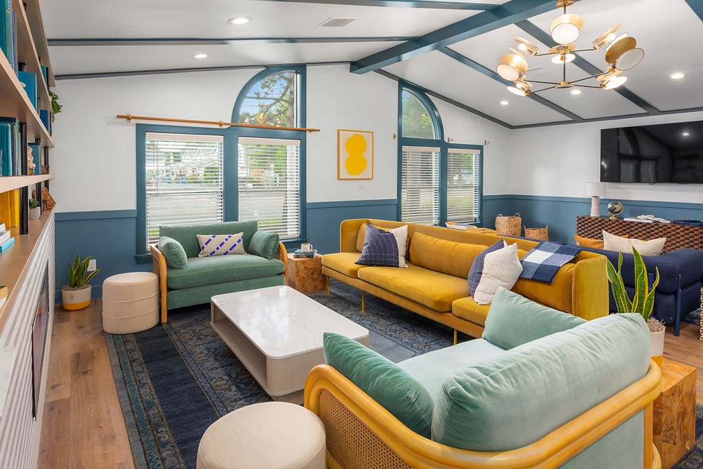 a living room with couches and chairs and a table