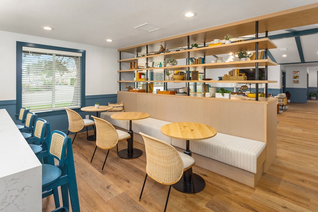 a dining room with tables and chairs and a counter with shelves
