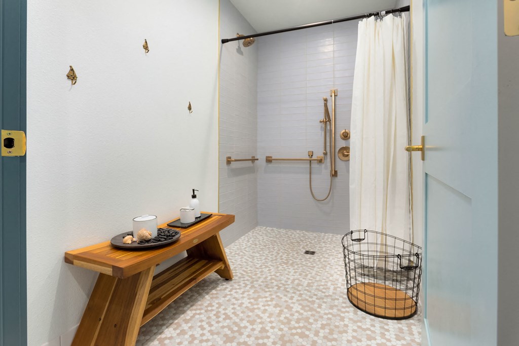 a bathroom with a shower and a wooden table