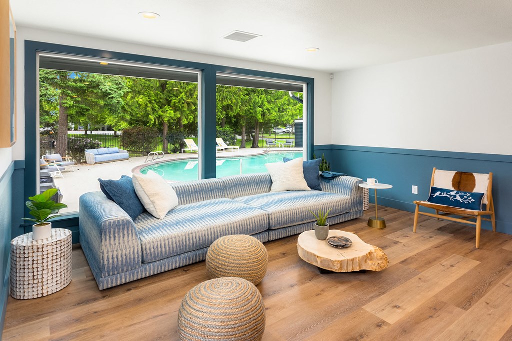 a living room with blue and white furniture and a pool