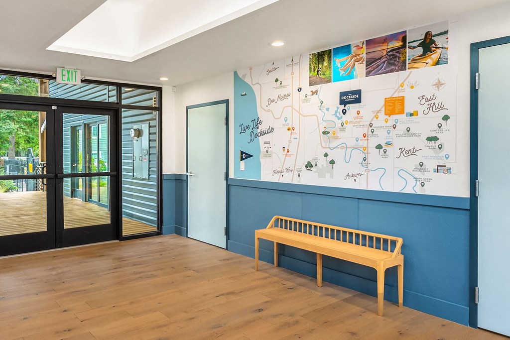 a hallway with a bench and a blue wall with a door