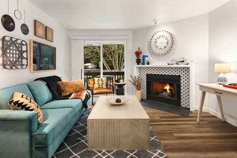 a living room with a blue couch and a fireplace