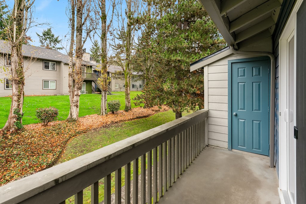 the view from the balcony of a house with a blue door