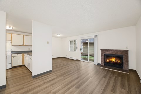 A living room with a fireplace and sliding glass doors.