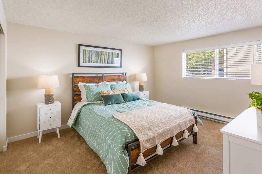 a bedroom with a bed and a window